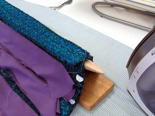 Pressing the seams fo the couture jacket.